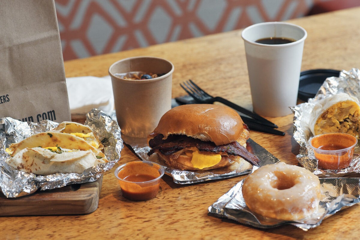 selection of grab & go breakfast, including breakfast burritos, tacos & sandwiches, donuts, and coffee drinks